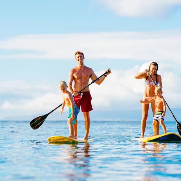 Happy family kayaking on the sea enjoying the clear waters and sunny day