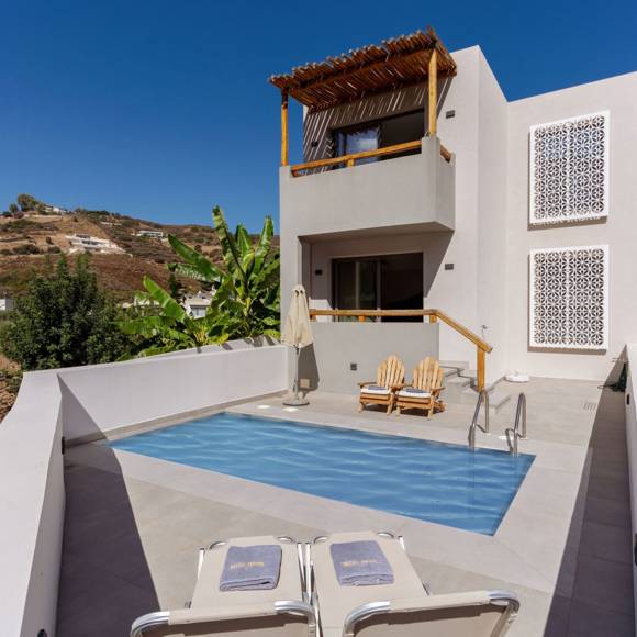 Exterior view of a maisonette suite with private pool, sun loungers and mountain backdrop