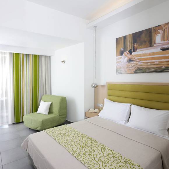 bright modern room with a double bed, an armchair, balcony access and minimalistic decor in natural tones